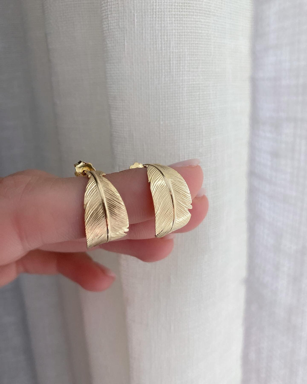 Orecchini piuma curvata